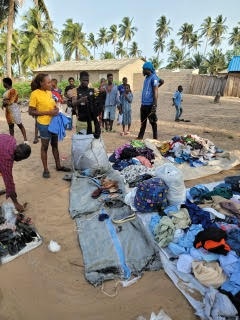 Refugees gathering their items on the ground